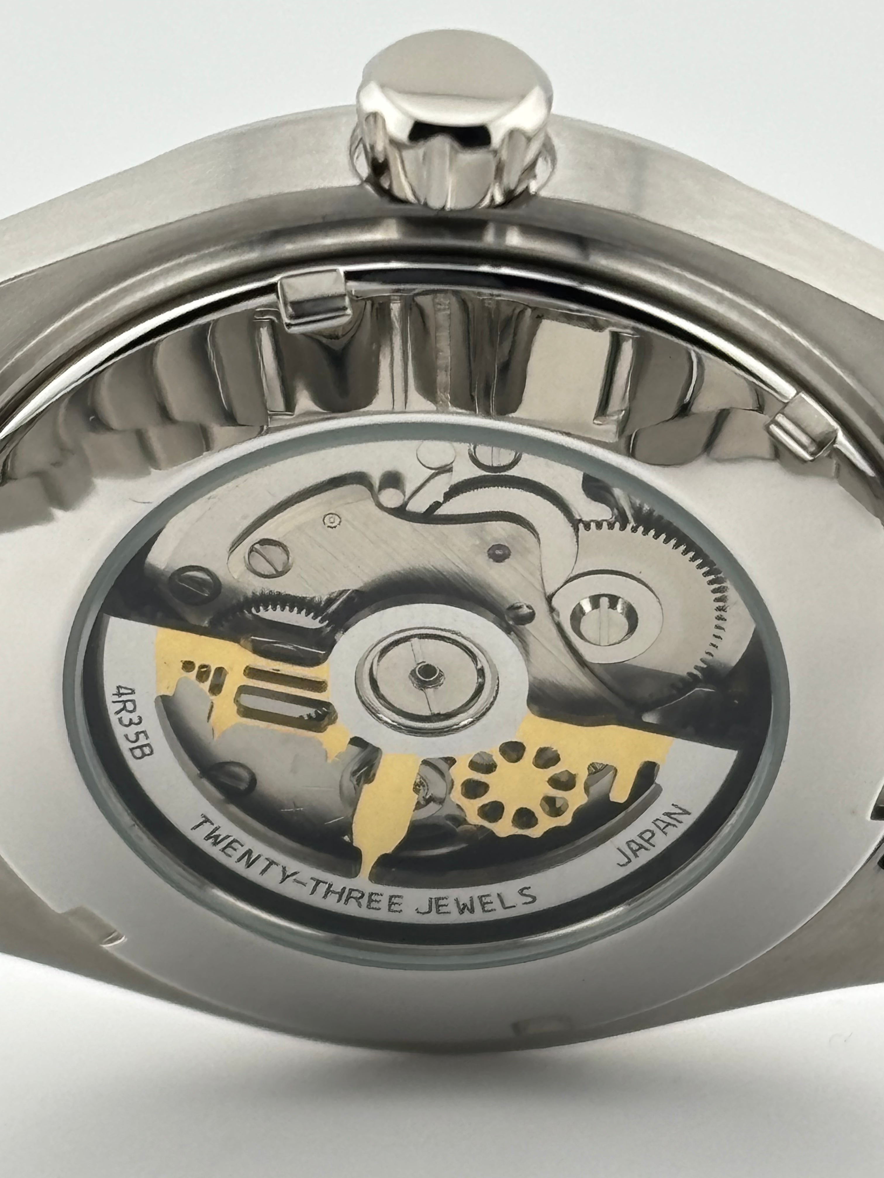 Mechanical sports watch with stainless steel case and bracelet, lumed hands and markers
